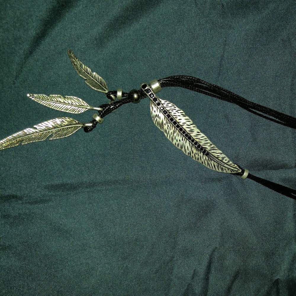 Silver colored feather necklace